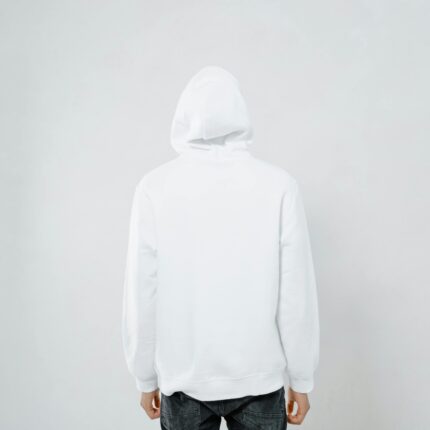 Person wearing a white hoodie facing away against a plain backdrop, offering blank space.